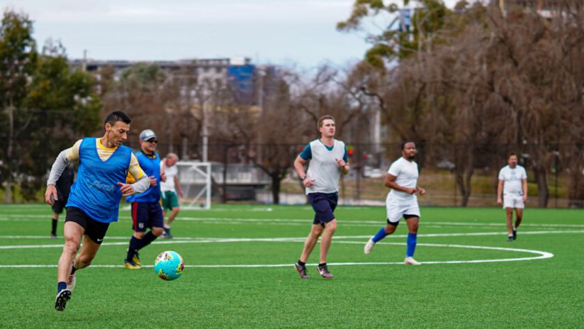 A group of men playing a game of soccer